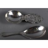 A modern silver dog-nose caddy spoon and another modern silver caddy spoon with Celtic style handle,