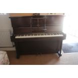 A W H Barnes iron frame overstrung full trichord, check action upright piano, in walnut case