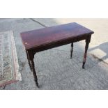 A late 19th century rosewood fold-over top card table, on turned supports, 38" wide x 19" deep x