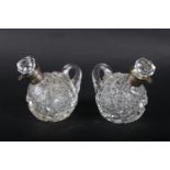 A pair Mappin & Webb cut glass silver collared condiment bottles, 3 1/2" high (chipped stoppers)
