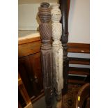 A pair of 19th century carved and spiral reeded bedposts, 55" high, and a similar larger pair, 67"