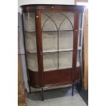 An Edwardian walnut and line inlaid shape front display cabinet enclosed Gothic lattice glazed door,