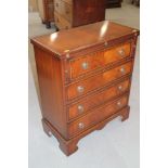 A bachelor's polished as mahogany chest with leather inset fold-over top, over four long drawers, on