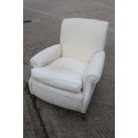 A Howard style deep-seat armchair with loose seat cushion, on square taper supports