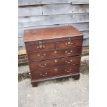 A bachelor's George III mahogany chest of two short and three graduated long drawers with slide,