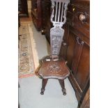 A carved oak spinning stool with fretwork back, on turned splay supports (for restoration)
