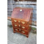 A mahogany and banded fall front bureau, the fitted interior over three long drawers with pierced
