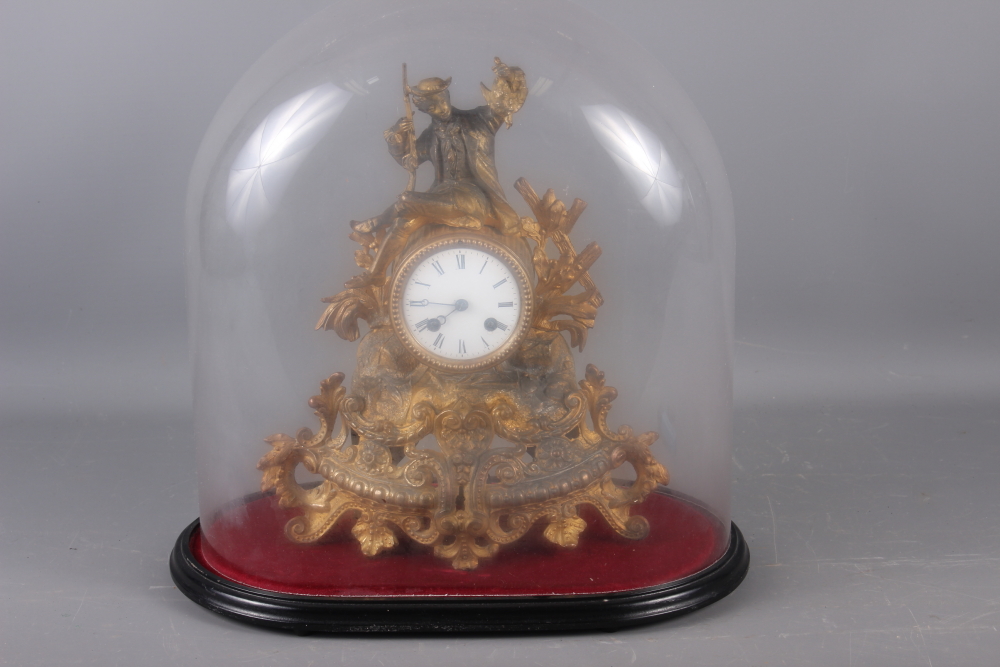 A 19th century gilt spelter mantel clock with hunter surmount, 14" high, under a glass dome shade,