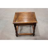 An oak low occasional table with through pegged top, on turned and stretchered splay supports, 18"