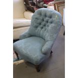 A late 19th century low seat tub chair, button upholstered in a blue brocade, on turned and castored