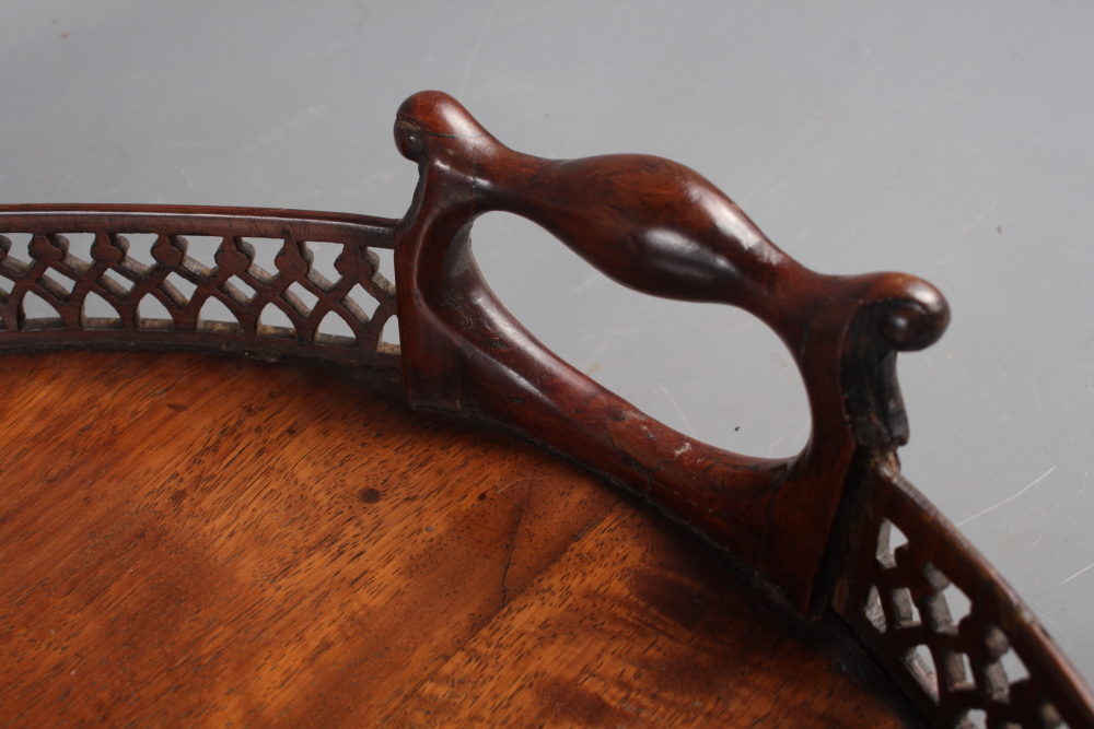 A late 19th century figured mahogany two-handled tray with pierced gallery, 29" wide (losses and - Image 3 of 4