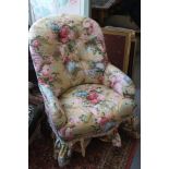 A late Victorian tub shape armchair, button upholstered in a floral chintz on an ochre ground