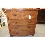 A Victorian mahogany bowfront chest of four long graduated drawers with turned knob handles, on