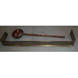 A late Victorian pierced brass fender curb, 58" wide, and a copper warming pan with turned ash