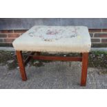 A 19th century stool with needlepoint seat, on square taper and stretchered supports, 13" square x