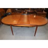 A G-Plan teak 'D' end extending dining table, 83" long x 44" wide x 28" high when fully extended,