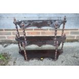 A 19th century fruitwood serpentine front three-tier open wall shelf, with bobbin turned supports,