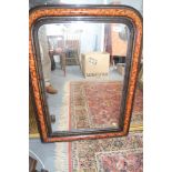 A rectangular shaped overmantel mirror with ebonised and tortoiseshell effect frame, 25" x 17"