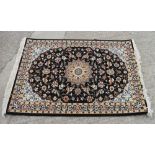 A fine woven full pile rug with Sharbas medallion design on a black ground, 56" x 40" approx