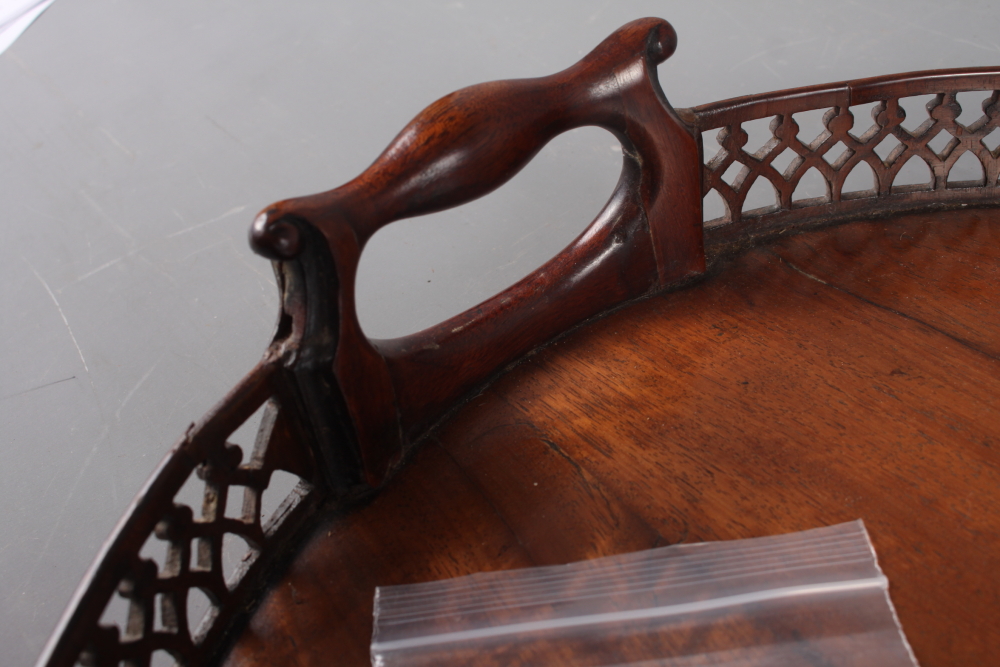 A late 19th century figured mahogany two-handled tray with pierced gallery, 29" wide (losses and - Image 2 of 4