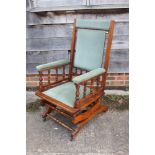 A walnut framed "American" rocking chair, upholstered in a sage Dralon