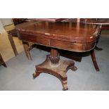 A Regency rosewood and brass inlaid fold-over tea table, on turned and acanthus carved column and