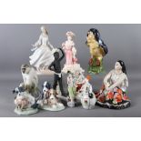 A Lladro figure of a girl, 10" high, two Nao figure groups of dogs and cats, a Golden Age figure, "