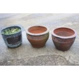 A pair of terracotta plant pots with undulated decoration, 16" dia x 12" high, and a copper planter,