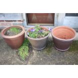 A pair of tapered terracotta plant pots, 12 1/4" dia x 9 1/4" high, and another similar