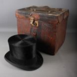 A Henry Heath Ltd black silk top hat, 8" x 6 1/4" (inside hat measurements), in a leather hat box