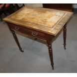 An Edwardian walnut writing desk with tooled lined top, fitted one drawer, on turned and castored