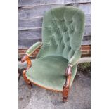 A Victorian mahogany open armchair, button upholstered in a green velour, on turned and carved