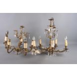 An ornate gilt metal five-light ceiling light with crystal drops and another smaller similar