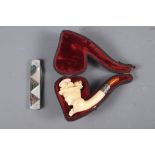 A Meerschaum pipe, formed as a lady's head with white metal mounts and amber mouth-piece (
