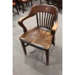 A 1930s polished as walnut desk elbow chair with panel seat, on square taper stretchered supports