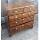 A mid Georgian walnut and banded chest of two short and three long graduated drawers with original