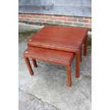 A nest of two Gordon Russell mahogany occasional tables, 24" wide x 18" deep x 16" high