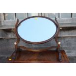 A 19th century mahogany oval swing frame toilet mirror, on skeleton stand with bone details, 18"