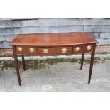 A George III mahogany bowfront side table, fitted three drawers with brass oval handles, on square