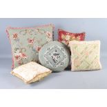 Three needlepoint cushions, a beadwork cushion and a silk cushion (worn)