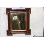 A 19th century rosewood and gilt framed rectangular wall mirror with bevelled plate, 19" x 17"
