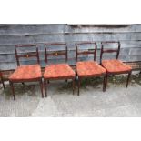 A set of seven 19th century mahogany side chairs with loose seat squabs, oval carved bar backs and