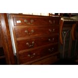 A late Georgian mahogany chest of four long graduated drawers with brass bail handles, on bracket