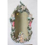 An early 20th century Dresden porcelain framed wall mirror, decorated roses, cherubs and merman,