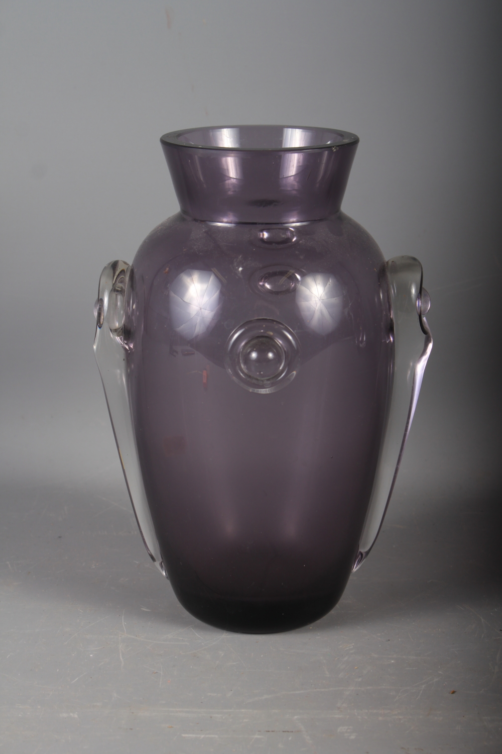 An early 20th century amethyst glass vase with applied decoration, 10" high