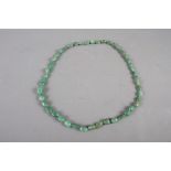 A jadeite graduated pebble bead necklace, 36" long and a malachite graduated bead necklace 27" long