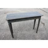 A grey finish oval wood side table with Gothic arch blind fret frieze, on canted square taper