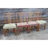 A set of four late Georgian carved ash and fruit wood side chairs with stuffed over seats and