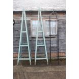 A pair of green painted garden obelisks, 104" high, and a black wrought garden obelisk, 96" high