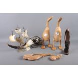 A pair of carved hardwood ducks, 15 1/2" high, two other wood carvings and a horn table lamp, in the